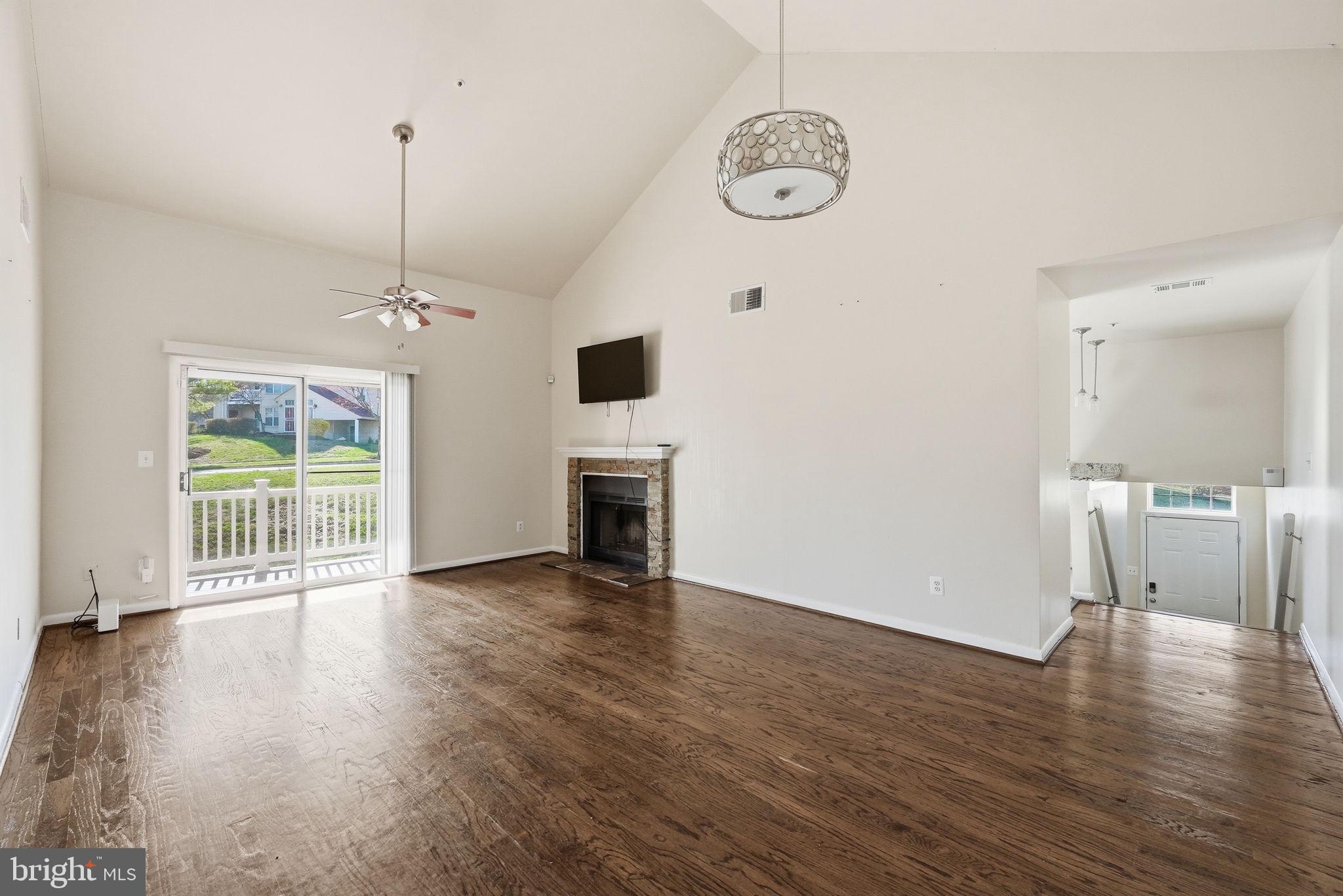 1003 Spring Valley Court Fort Washington, MD 20744 - Photo 4 of 25 a view of a livingroom with wooden floor and a ceiling fan