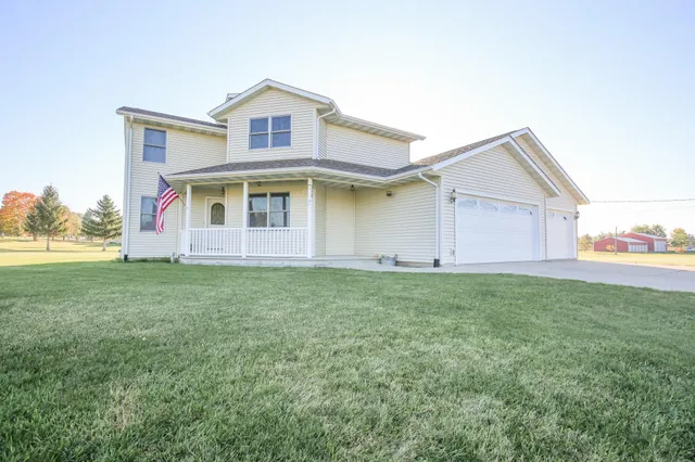 a front view of house with yard and garage