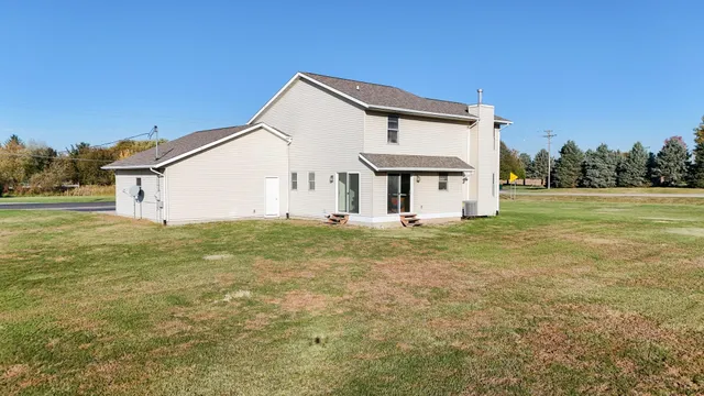 a view of a white house with a yard