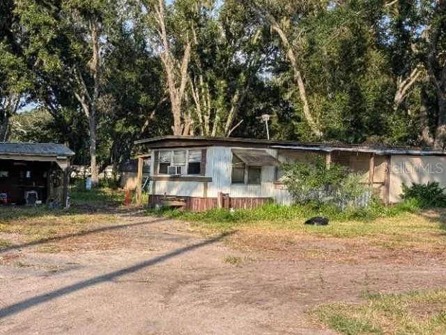 a view of house with outdoor space and sitting area