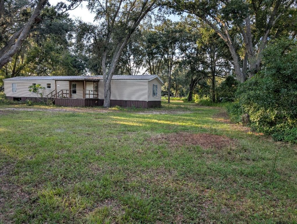 16188 Boyette Road Riverview, FL 33569 - Photo 2 of 13 a front view of a house with garden