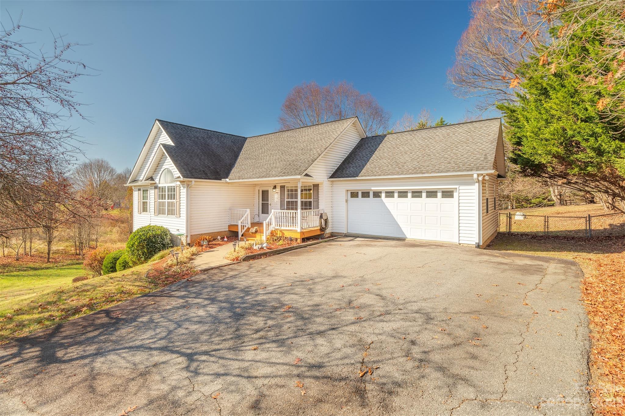 1315 Alexander Road Leicester, NC 28748 - Photo 1 of 28 a front view of a house with a yard and garage