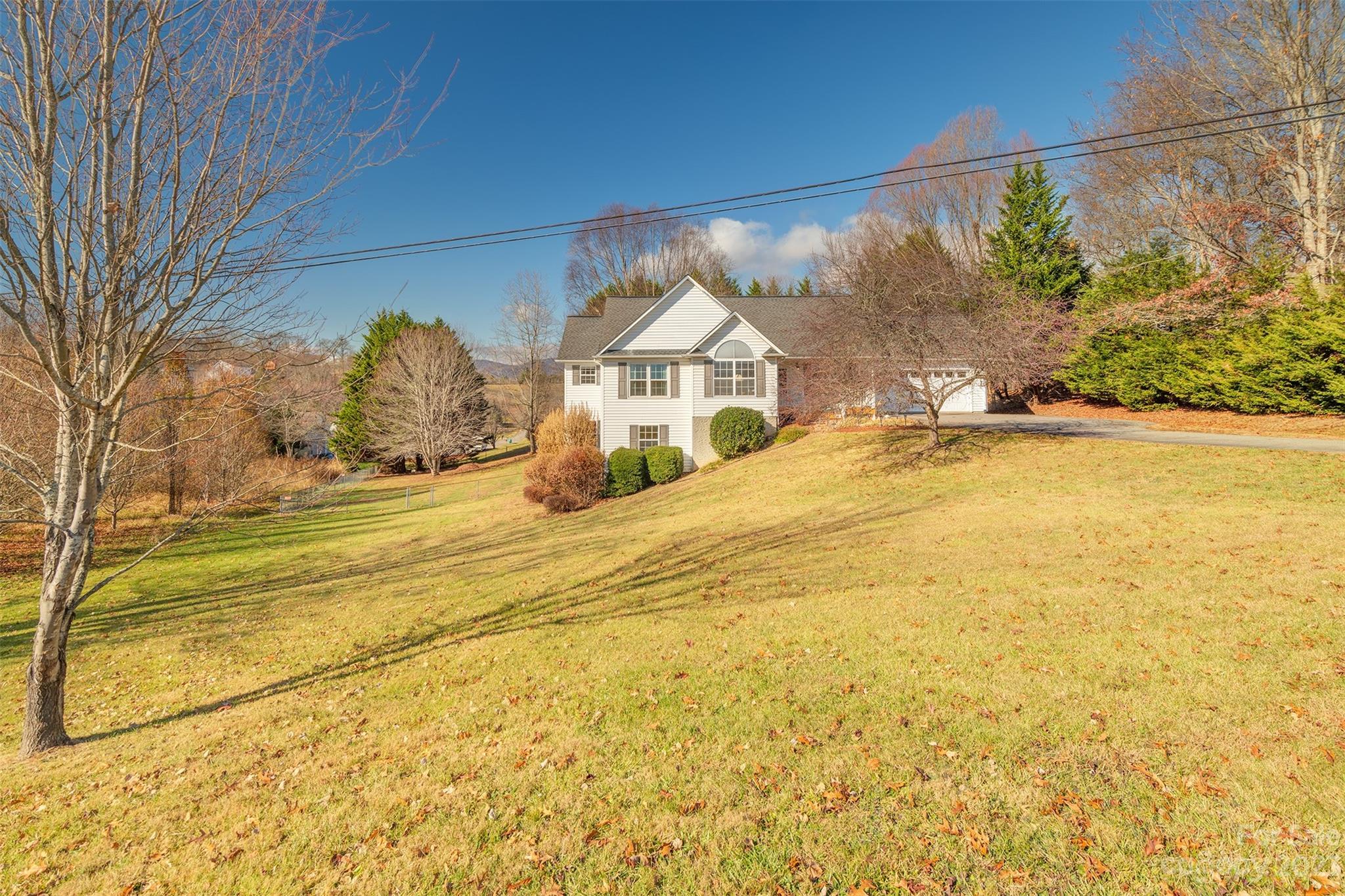 1315 Alexander Road Leicester, NC 28748 - Photo 2 of 28 a view of a house with a yard and a large tree