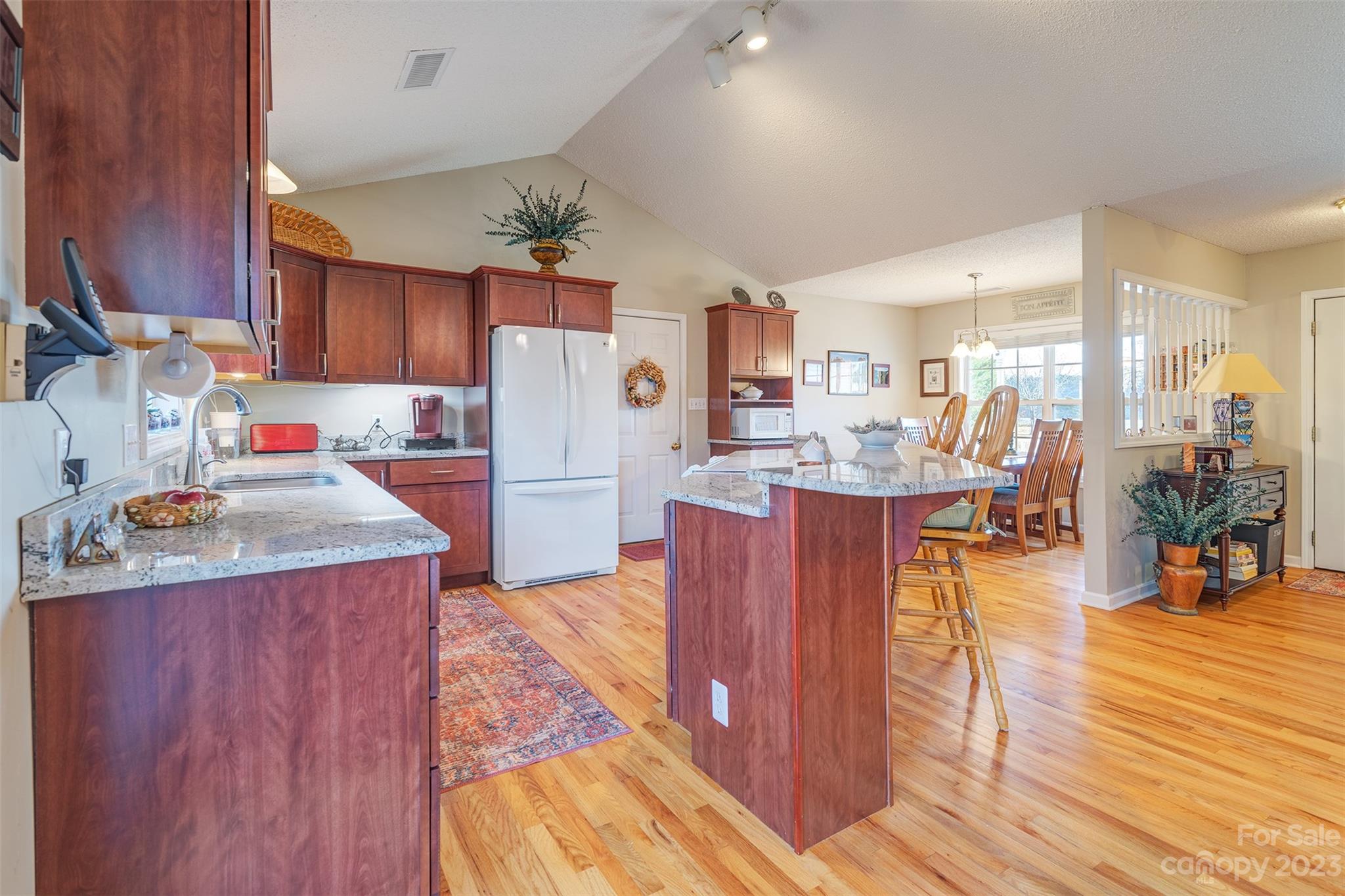 1315 Alexander Road Leicester, NC 28748 - Photo 9 of 28 a kitchen with stainless steel appliances wooden floors and wooden cabinets
