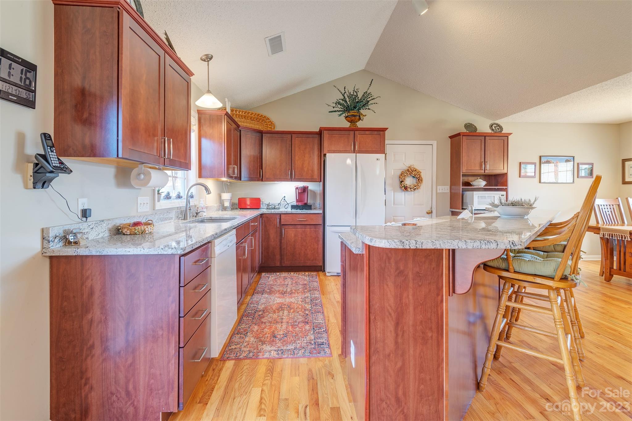 1315 Alexander Road Leicester, NC 28748 - Photo 10 of 28 a kitchen with kitchen island granite countertop a sink stove and cabinets