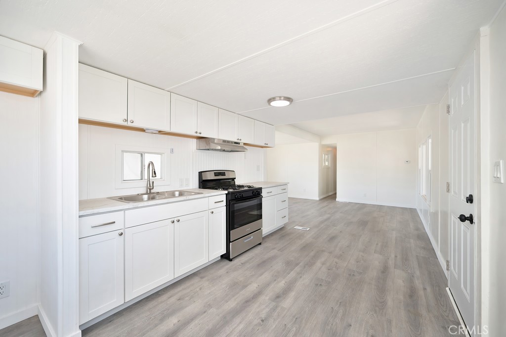 26455 Paradise Valley Road, Unit 86 Warner Springs, CA 92086 - Photo 10 of 34 a kitchen with white cabinets and white appliances
