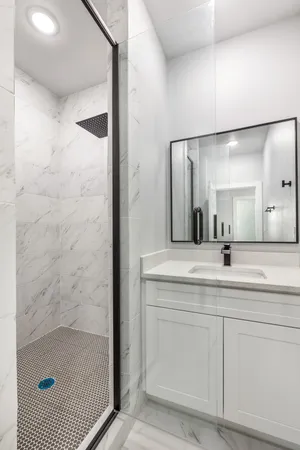 a bathroom with a shower sink and mirror