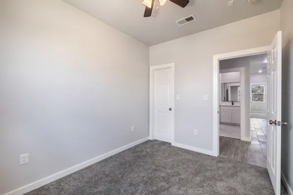 an empty room with an entrance to other room