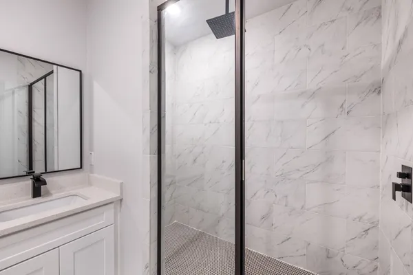 a bathroom with a shower and a sink