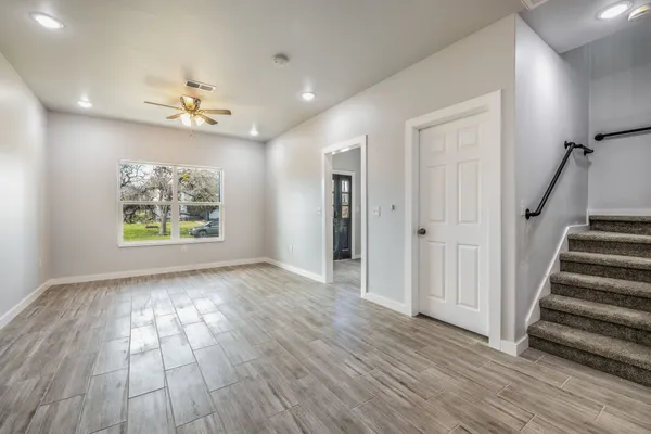 wooden floor in an empty room with a window