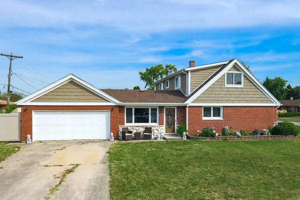 a front view of house with yard and green space