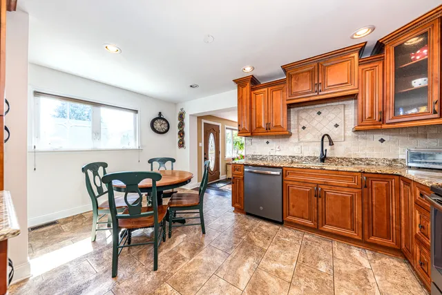 a kitchen with granite countertop a sink cabinets and window