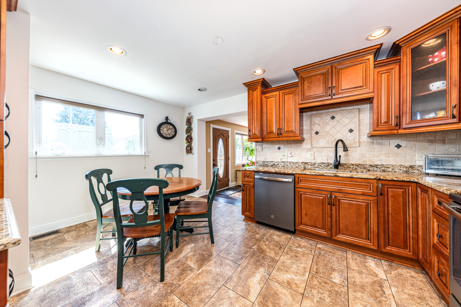 9236 Pembroke Lane Bridgeview, IL 60455 - Photo 22 of 40 a kitchen with granite countertop a sink cabinets and window