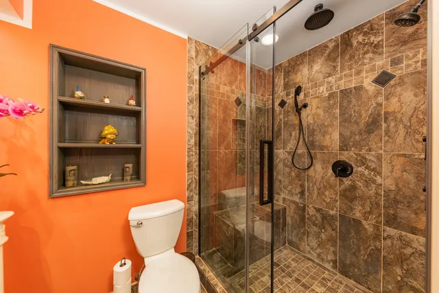 a bathroom with a toilet and shower