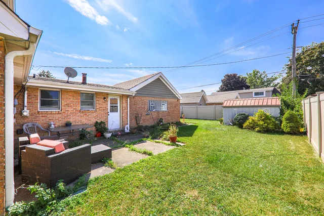 a front view of a house with a yard outdoor seating and garage