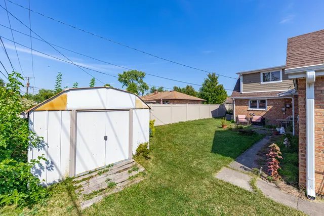 a view of backyard with potted plants and entertaining space