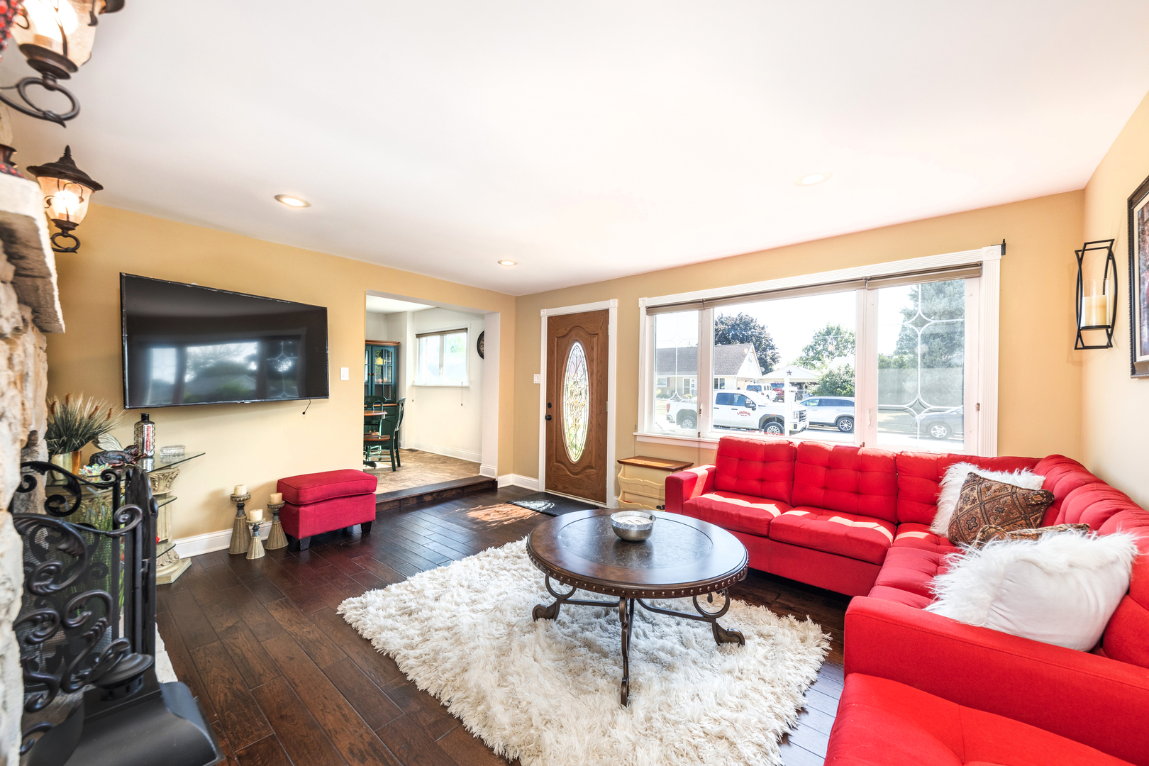 9236 Pembroke Lane Bridgeview, IL 60455 - Photo 8 of 40 a living room with furniture a flat screen tv and a large window