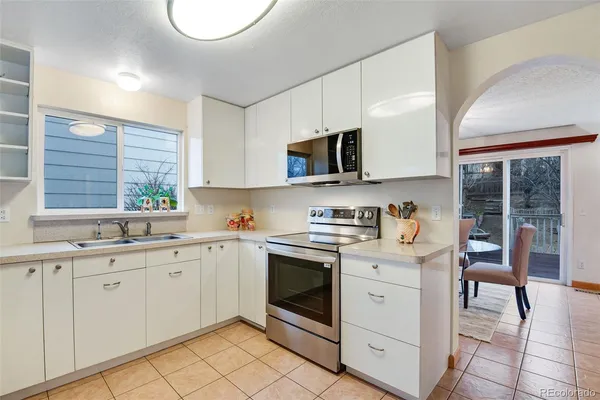 a kitchen with a sink stove and cabinets