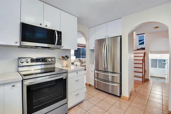 a kitchen with cabinets stainless steel appliances and a counter space