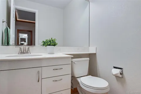 a bathroom with a toilet a sink and mirror