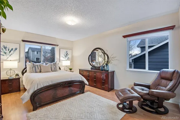 a bedroom with furniture and a large window