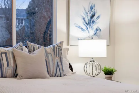 a bedroom with a bed and a painting on the wall