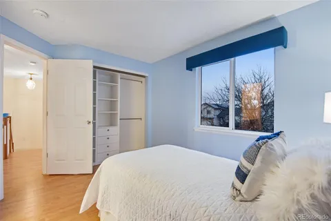 a bedroom with a bed and a painting on the wall