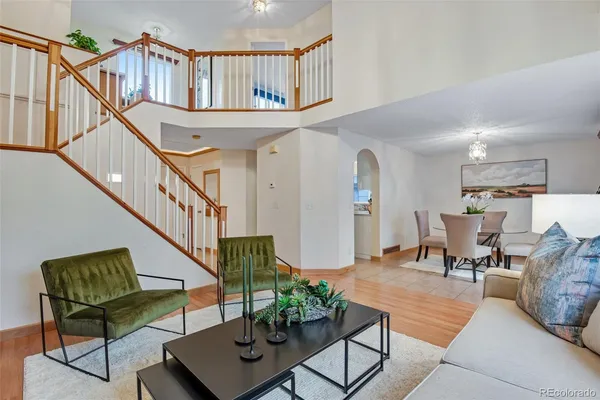 a living room with furniture and a book shelf