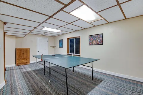 a view of a room with furniture and wooden floor