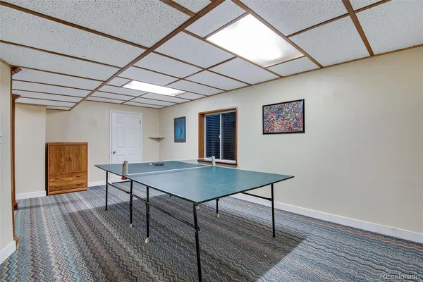 a view of a room with furniture and wooden floor