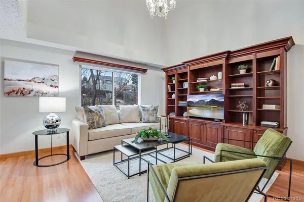 a living room with furniture a rug and a large window