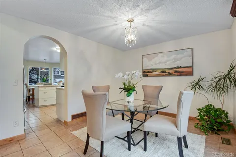 a view of a dining room with furniture and chandelier
