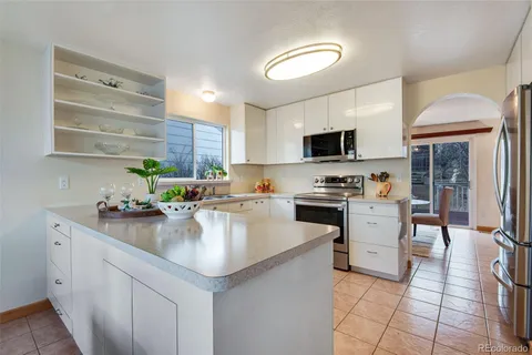 a kitchen with stainless steel appliances granite countertop a sink stove and cabinets
