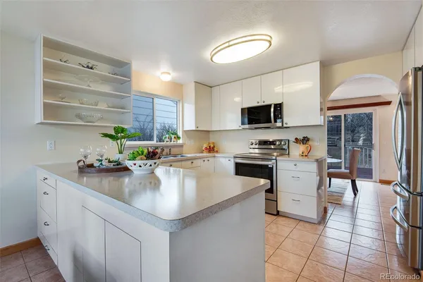 a kitchen with stainless steel appliances granite countertop a sink stove and cabinets