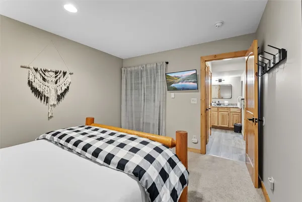 a bedroom with a bed and a view of bathroom