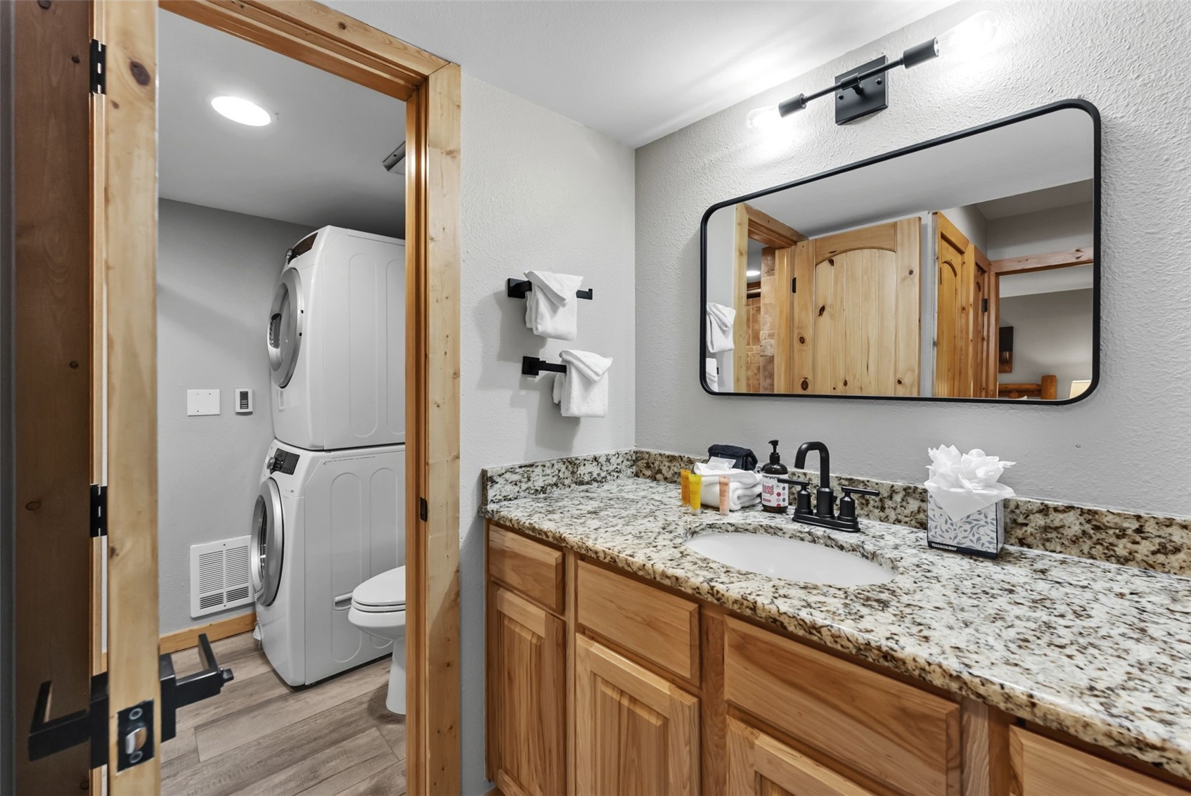 325 Four O Clock Road North, Unit B103 Breckenridge, CO 80424 - Photo 12 of 19 a bathroom with a granite countertop sink vanity mirror and toilet
