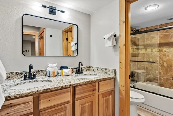 a bathroom with a granite countertop sink mirror and double