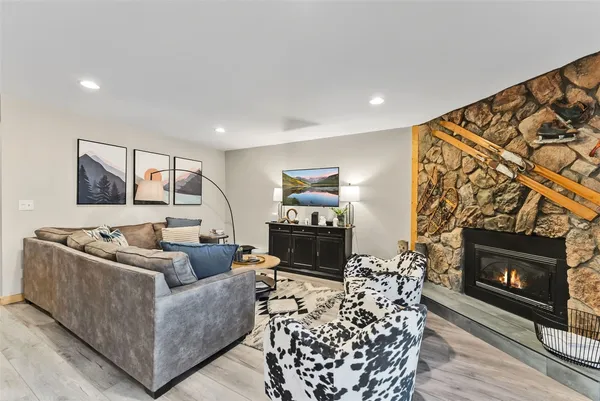 a living room with furniture a flat screen tv and a fireplace