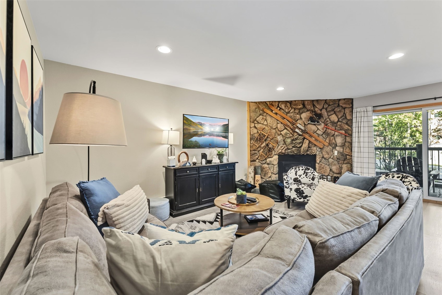 325 Four O Clock Road North, Unit B103 Breckenridge, CO 80424 - Photo 9 of 19 a living room with furniture a large window and a fireplace