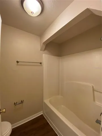 a bathroom with a shower and toilet