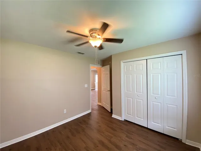 a view of an empty room and wooden floor
