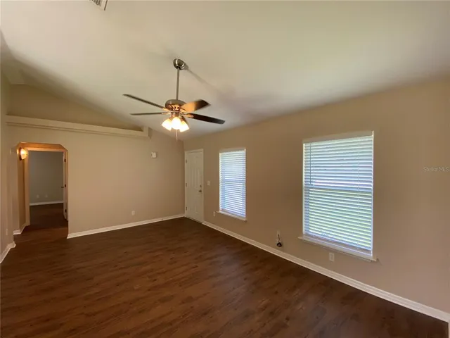 a view of a livingroom with a ceiling fan and window