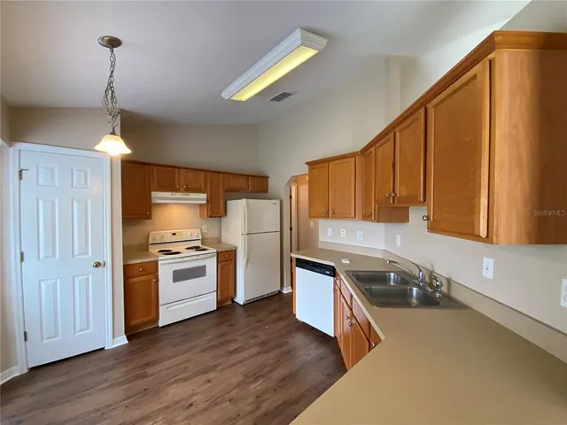 a kitchen with a sink appliances and cabinets