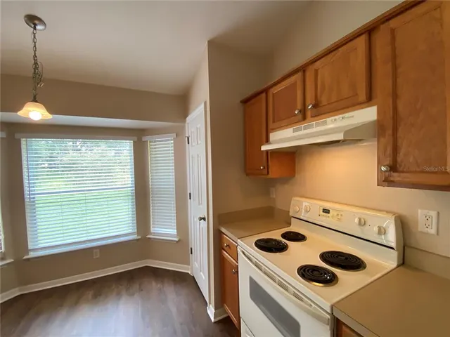 a kitchen with a stove and a microwave