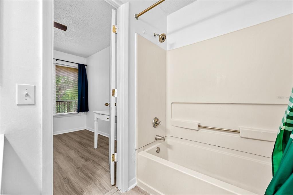 3921 Southwest 34th Street, Unit 208 Gainesville, FL 32608 - Photo 12 of 33 a bathroom with a bathtub and a shower