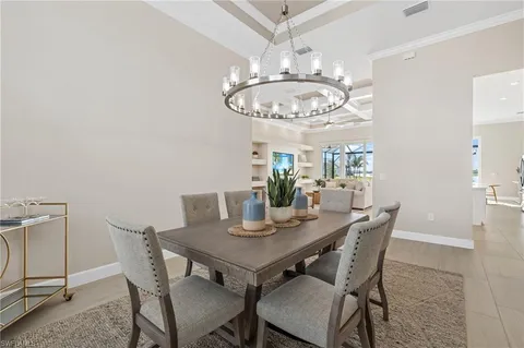 a view of a dining room with furniture and chandelier