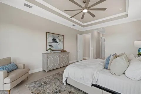 a bedroom with a bed and ceiling fan
