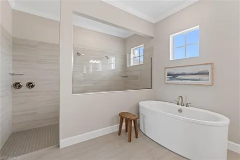 a white bath tub sitting next to a white sink