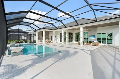 a view of a patio with a table and chairs under an umbrella
