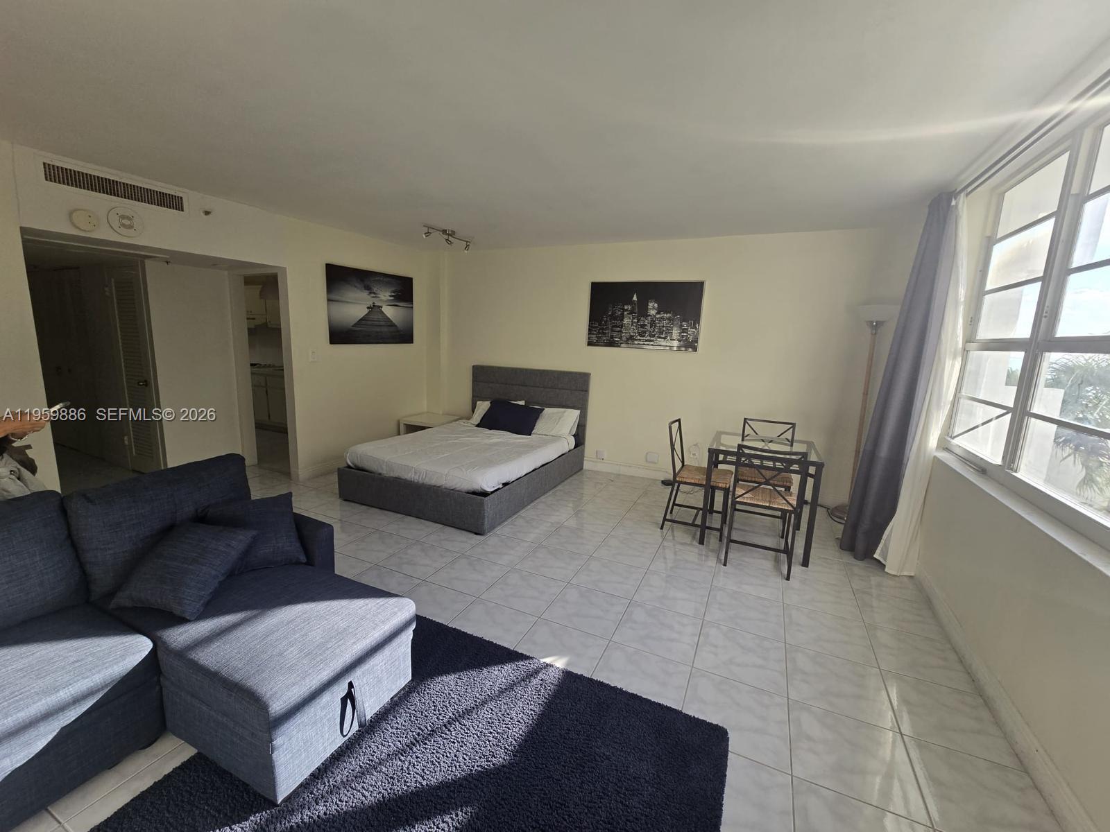 100 Lincoln Road, Unit 532 Miami Beach, FL 33139 - Photo 3 of 12 a living room with furniture and a window